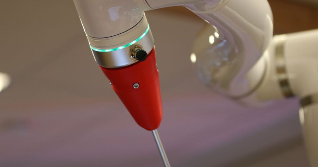 kuka robot hand featured image showing industrial robotic arm in a factory environment