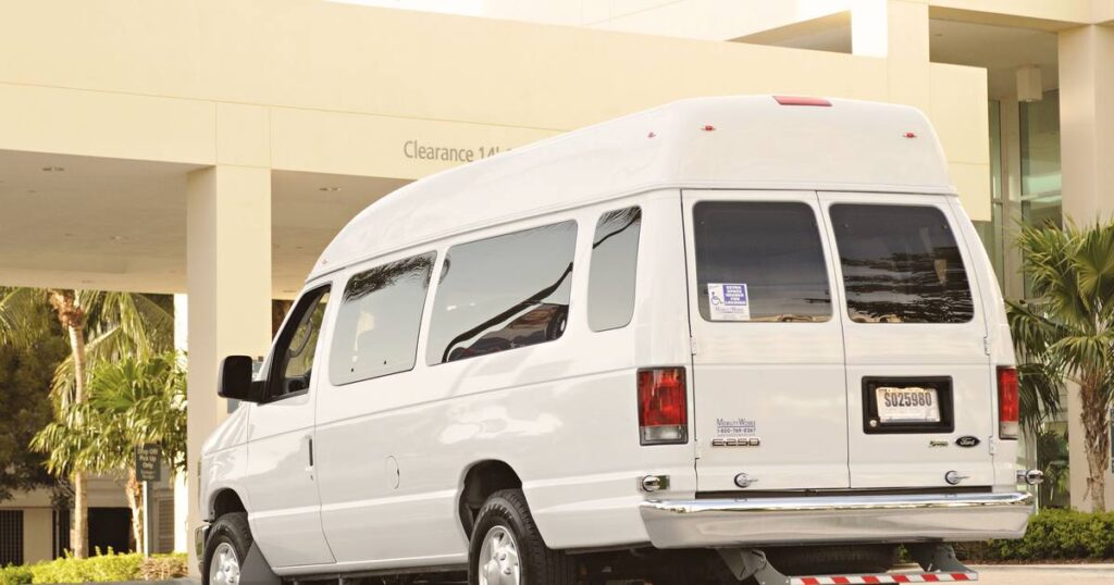 White commercial passenger van used for corporate employee shuttle and crew transportation services